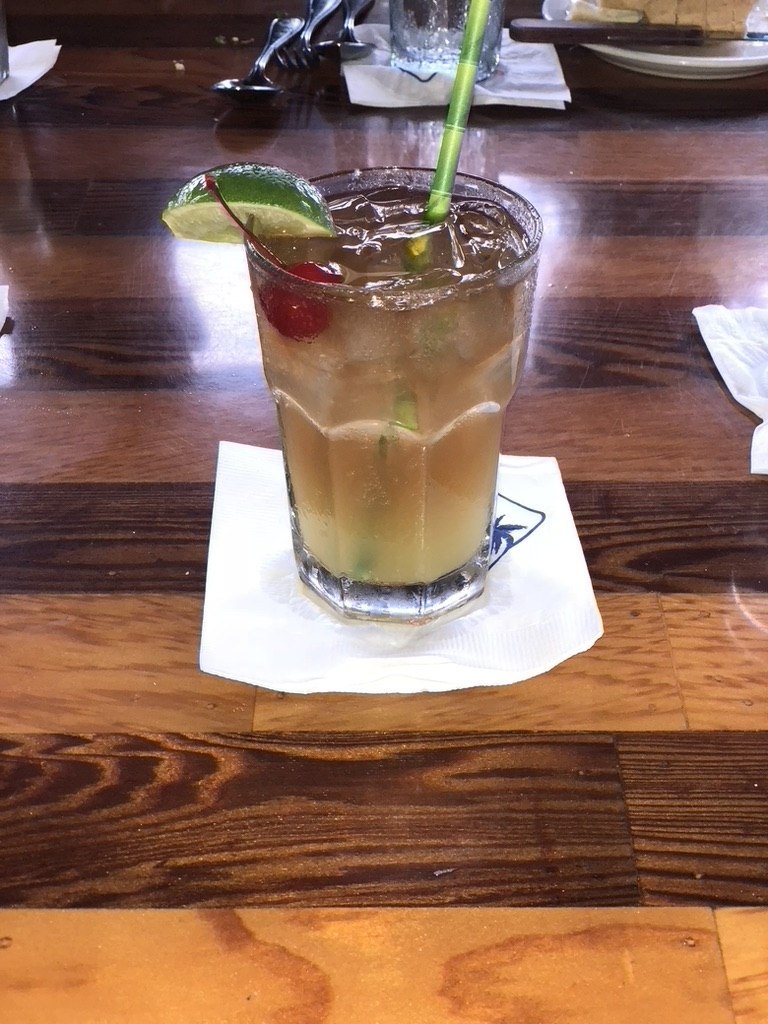 A cocktail with lime and cherry at Buzz’s in Kailua